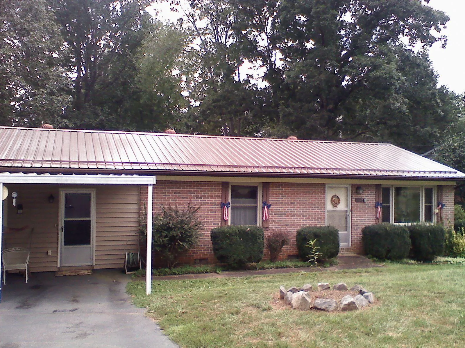 Bronze metal roof and carport on a brick ranch home — Roof Repair work by our crew in Export