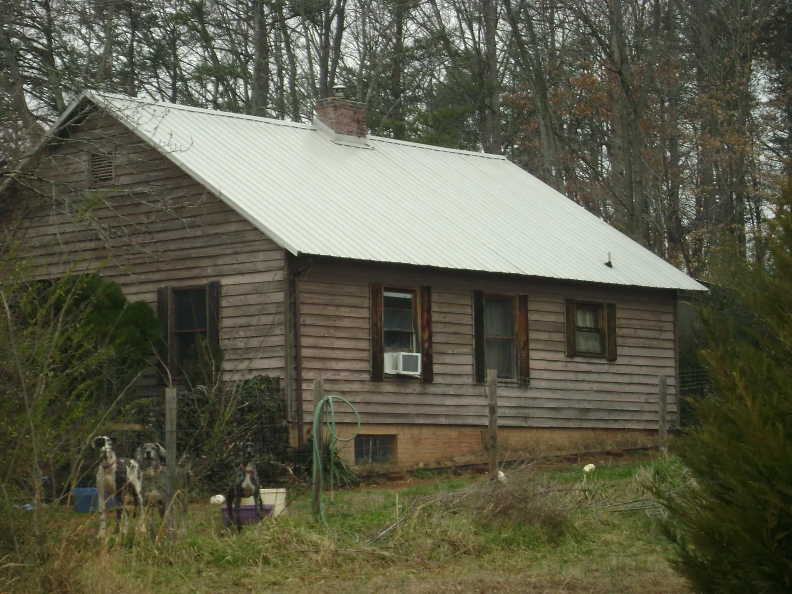 White metal roof on an old wood sided farmhouse, from a Metal Roof Installation job in Export